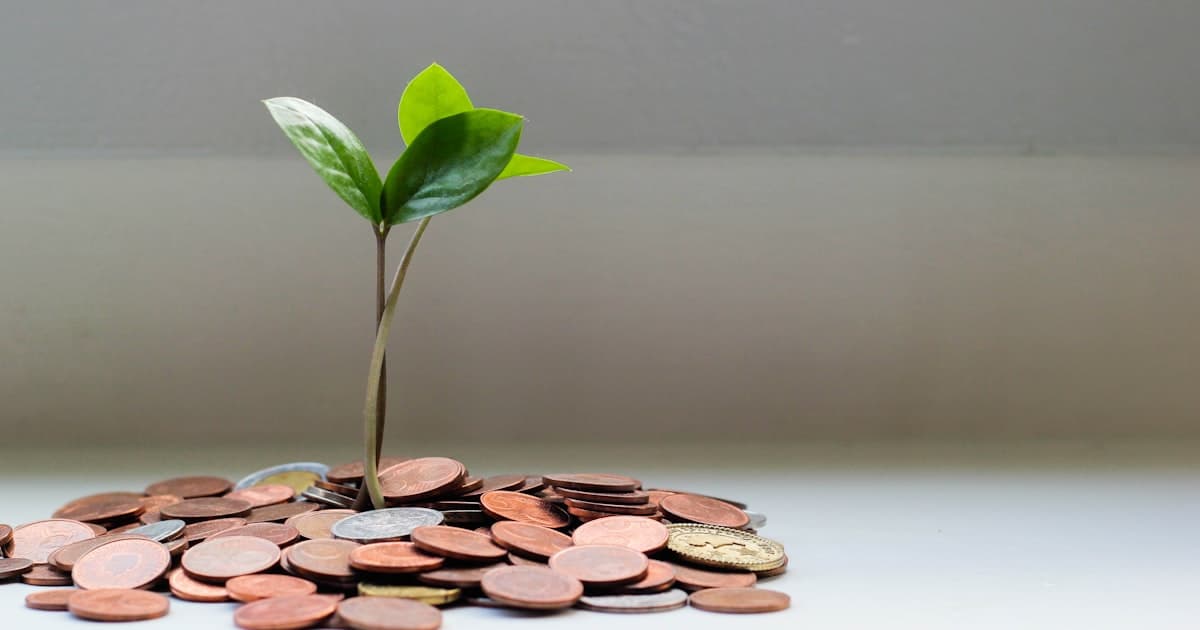 Money saving concept with piggy bank and car keys representing ways to lower car insurance costs